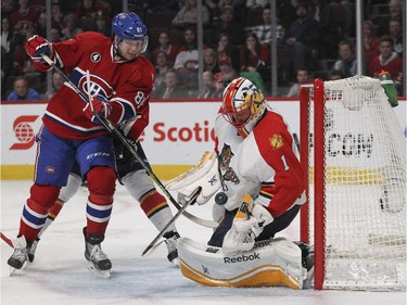 Florida Panthers goalie Roberto Luongo makes a save as Montreal Canadiens Lars Eller looks for the rebound during third period of National Hockey League game in Montreal Thursday February 19, 2015.