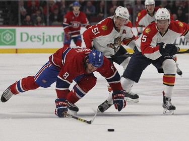 Montreal Canadiens Brandon Prust stumbles while being pursued by Florida Panthers  Aaron Ekblad, right, and Brian Campbell during first period of National Hockey League game in Montreal Thursday February 19, 2015.