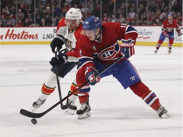 Montreal Canadiens Brendan Gallagher has his stick lifted off the puck by Florida Panthers Tomas Fleischmann during third period of National Hockey League game in Montreal Thursday February 19, 2015.