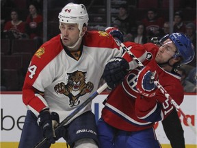 Montreal Canadiens David Desharnais takes an elbow to the chest from Florida Panthers Erik Gudbranson during first period of National Hockey League game in Montreal Thursday February 19, 2015.
