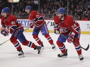 Montreal Canadiens defenceman Jarred Tinordi, right, watches play against the Florida Panthers with teammates Lars Eller, left, and Jiri Sekac during second period of National Hockey League game in Montreal Thursday February 19, 2015.