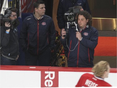 Montreal Canadiens equipment manager Patrick Langlois, second from left, watches warmup prior to National Hockey League game against the Florida Panthers in Montreal Thursday February 19, 2015.