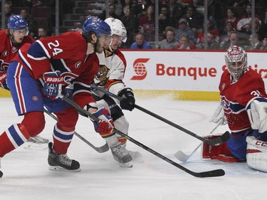 Montreal Canadiens Jarred Tinordi, 24, checks Florida Panthers Aleksander Barkov in front of goalie Carey Price during second period of National Hockey League game in Montreal Thursday February 19, 2015. Canadiens Jacob De La Rose is rear left.