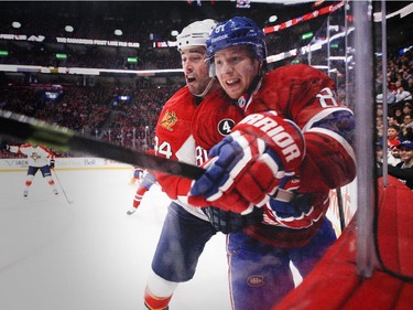 Montreal Canadiens Lars Eller, right, and Florida Panthers Erik Gudbranson collide against the boards during National Hockey League game in Montreal Thursday February 19, 2015.