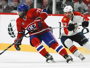 Montreal Canadiens P.K. Subban controls the puck despite pressure from Florida Panthers Dave Bolland during National Hockey League game in Montreal Thursday February 19, 2015.