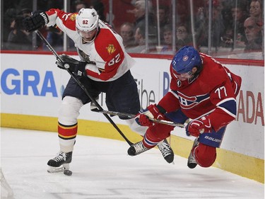Montreal Canadiens Tom Gilbert loses his footing as he's checked by Florida Panthers Tomas Kopecky during second period of National Hockey League game in Montreal Thursday February 19, 2015.
