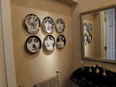 Voyeur plates by Italian artist Piero Fornasetti in a powder room.