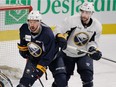 Buffalo Sabres defenceman Josh Gorges (left) holds his position in front of the net while under pressure from teammate Matt Moulson during practice at the Bell Centre in Montreal on Feb. 2 , 2015.