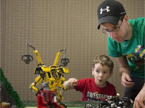 MONTREAL, QUE.: FEBRUARY 21, 2015 --  Benjamin Bouthillette left is impressed with a lego transformer crane as his father Sebastien  puts together a lego display at The Pointe-Claire Library as it hosts a one-day exhibition called the Means of Transportation. Saturday, February 21, 2015. (Peter McCabe / MONTREAL GAZETTE)