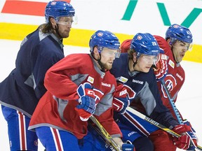 From left to right, the Canadiens' Tom Gilbert, Jiri Sekac, Nathan Beaulieu and Max Pacioretty battle for position during practice at the Bell Sports Complex in Brossard on Feb. 23, 2015.