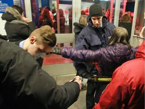 Security guards check people at the main entrance of  the Bell Centre in Monday, February 23, 2015 for a concert by Bryan Adams.