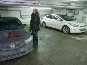 Sarah Benaim with her car, one of four that were spray-painted with swastikas, in the garage of her apartment building on Cote St Luc Rd. in Montreal, Feb. 24, 2015.