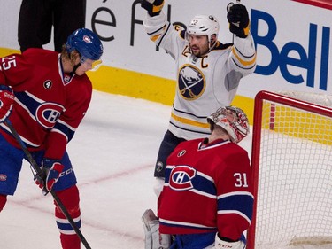 Buffalo Sabres right wing Brian Gionta celebrates Buffalo Sabres left wing Matt Moulson's (not seen) goal against Montreal Canadiens goalie Carey Price, bottom right, as Montreal Canadiens left wing Jacob De La Rose, left, looks on during NHL action at the Bell Centre in Montreal on Tuesday February 3, 2015.