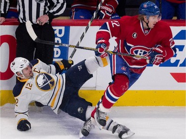Buffalo Sabres right wing Brian Gionta, left, gets dumped to the ice by Montreal Canadiens right wing Dale Weise during NHL action at the Bell Centre in Montreal on Tuesday February 3, 2015.