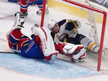 Buffalo Sabres right wing Patrick Kaleta, right, grimaces as he crashes into Montreal Canadiens goalie Carey Price during NHL action at the Bell Centre in Montreal on Tuesday February 3, 2015.