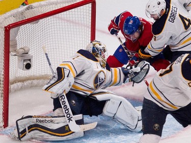 Montreal Canadiens centre David Desharnais finds a hole and scores the Canadiens second goal against Buffalo Sabres goalie Jhonas Enroth, left, as Buffalo Sabres defenceman Josh Gorges tries to clear him from the crease during NHL action at the Bell Centre in Montreal on Tuesday February 3, 2015.