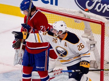 Montreal Canadiens defenceman Nathan Beaulieu, left, looks away as Buffalo Sabres left wing Matt Moulson points to Buffalo Sabres right wing Brian Gionta, not seen, after scoring on a pass from Gionta during NHL action at the Bell Centre in Montreal on Tuesday February 3, 2015.