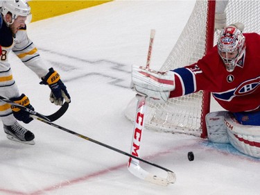 Montreal Canadiens goalie Carey Price, right, pulls in a loose puck as Buffalo Sabres centre Zemgus Girgensons struggles with Montreal Canadiens defenceman P.K. Subban, left, during NHL action at the Bell Centre in Montreal on Tuesday February 3, 2015.