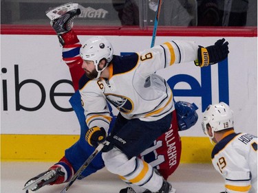 Montreal Canadiens right wing Brendan Gallagher gets turned upside down by Buffalo Sabres defenceman Mike Weber, centre, as Buffalo Sabres centre Cody Hodgson looks on during NHL action at the Bell Centre in Montreal on Tuesday February 3, 2015.