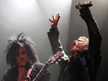 Veteran rocker Billy Idol (right) reaches up during a solo by guitarist Steve Stevens at the Metropolis in Montreal Tuesday, February 3, 2015. He's touring behind his first album in eight years, Kings and Queens of the Underground.
