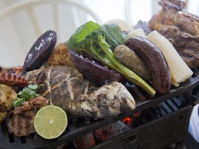 Parillada at La Lavanderie features chorizo, fish cornish hen, octopus and a variety of vegetables .