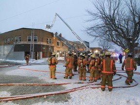 Montreal firefighters battle a fire at a two-storey building in La Salle, Feb. 4, 2015.