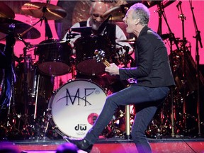 Guitarist/ singer Lindsey Buckingham of the band Fleetwood Mac lets go a kick in front of drummer Mick Fleetwood during the band's show at the Bell Centre in Montreal on Thursday, February 5, 2015.