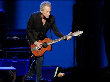 Guitarist/ singer Lindsey Buckingham of the band Fleetwood Mac leans in towards front row fans during the band's show at the Bell Centre in Montreal on Thursday, February 5, 2015.