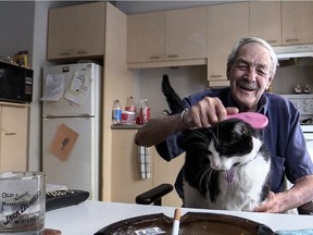 The number of rooming houses is dwindling yet they are the last stop before homelessness and the first option for people who escape from the street. Tenant Robert Smith grooms his cat, Pizza in his apartment in Montreal.