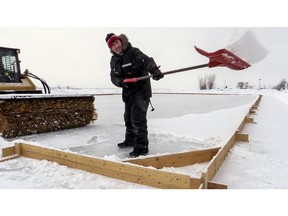 André Lefebvre shovels snow from a pond hockey rink in Lachine, on Friday, Feb. 6, 2015.