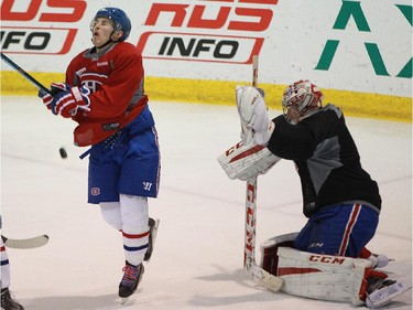 Brendan Gallagher of the Montreal Canadiens winces as he is hit by a shot from the point as he stood in front of goalie Carey Price at practice at Bell Sports Complex in Brossard in Montreal, on Friday, February 6, 2015.