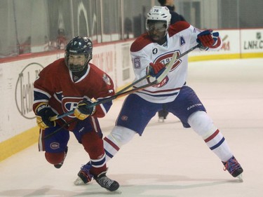 P.K. Subban of the Montreal Canadiens hooks Tristan Gagné of the AAA pee wee team called Conquérants des Basses-Laurentides during a scrimmage at Bell Sports Complex in Brossard in Montreal, on Friday, February 6, 2015. The team will be representing the Canadiens at the upcoming Quebec City pee wee tournament.