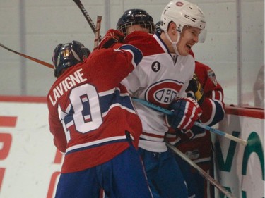 William Lavigne of the AAA pee wee team called Conquérants des Basses-Laurentides and a couple of his teammates, 'gang-up' on Brendan Gallagher during a scrimmage at Bell Sports Complex in Brossard in Montreal, on Friday, February 6, 2015.