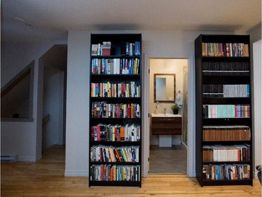 Large book shelves frame the entrance to the bathroom. Both owners are passionate about books.