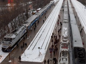 Downtown workers and other passengers board the AMT commuter trains at the Lucien-L'Allier station in this cityscape view in Montreal on Tuesday, January 29, 2013.
