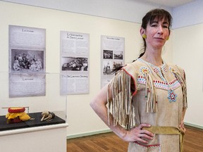 MONTREAL, QUE.: JANUARY 30, 2015 -- Across the Lake is a new exhibition at the Dorval museum that explores the relationship that has existed from the days of New France between Mohawks in Kahnawake and people in Dorval. Barbara Kaneratonni Diabo wears a buckskin dress at the museum in Dorval, on Friday, January 30, 2015 that originally belonged to her grandmother. (Dave Sidaway / MONTREAL GAZETTE)