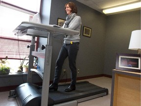 Jill Barker seen working at her treadmill desk at her office at McGill University in this file photo dated March 20, 2013.