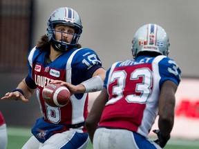 MONTREAL, QUE.: NOVEMBER 16, 2014-- Montreal Alouettes quarterback Jonathan Crompton, left, hands the ball off to Montreal Alouettes running back Brandon Rutley during CFL semifinal action at Molson Stadium  in Montreal on Sunday November 16, 2014.  The Alouettes won the game 50-17. (Allen McInnis / MONTREAL GAZETTE)