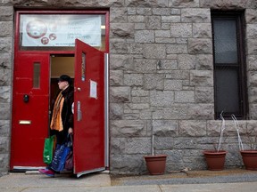 Lucie Barrette carries her food basket as she leaves Share the Warmth in Point St. Charles Nov. 18, 2013.