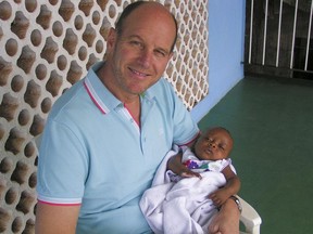Claude Perras with his adopted daughter Ella in Sierra Leone on November 4, 2014.