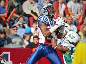 Alouettes receiver Duron Carter catches a touchdown pass over Saskatchewan Roughriders defensive back Rod Williams during CFL game at Molson Stadium on Oct. 13, 2014.