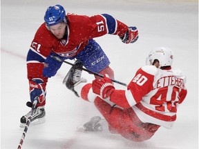 The Canadiens' David Desharnais knocks over the Detroit Red Wings' Henrik Zetterberg during game at the Bell Centre on Oct. 21, 2014. The Canadiens won 2-1 in overtime.