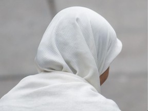 File photo: Two women wearing hijabs at Emilie-Gamelin park before a demonstration opposing the proposed Charter of Quebec Values in downtown Montreal on Saturday, September 14, 2013.