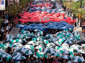 Walkers march down Ste-Catherine St. during Centraide's annual fundraising kick off.