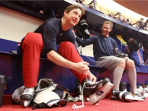 Colby Armstrong (left) and Erik Cole take off their skates after practice at the Bell Sports Complex in Brossard on Feb. 17, 2013.