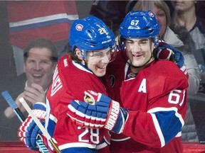 Montreal Canadiens' Max Pacioretty (67) celebrates with teammate Nathan Beaulieu after scoring against the Columbus Blue Jackets during first period NHL hockey action in Montreal, Saturday, February 21, 2015.