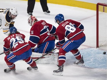 Buffalo Sabres' Nikita Zadorov scores past Montreal Canadiens goalie Carey Price as Canadiens Jacob De La Rose, left, and Lars Eller look on during first period NHL hockey action Tuesday, February 3, 2015 in Montreal.