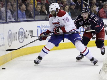 Montreal Canadiens' P.K. Subban, left, tries to clear the puck as Columbus Blue Jackets' Mark Letestu defends during the second period of an NHL hockey game Thursday, Feb. 26, 2015, in Columbus, Ohio.