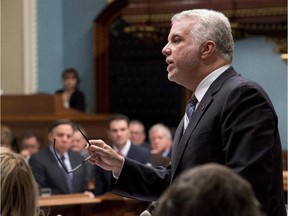 Quebec Premier Philippe Couillard responds to second opposition leader Francois Legault, left, during question period Wednesday, December 3, 2014 at the legislature in Quebec City.