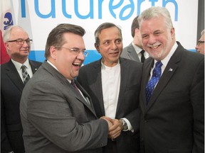Newly appointed Future Earth head Paul Shrivastava, centre, is congratulated by Mayor Denis Coderre, left, and Quebec Premier Philipe Couillard, right, at a news conference Friday, February 13, 2015 in Montreal to announce the creation of the Global Secretariat of Future Earth which coordinates research on climate change and sustainable development .